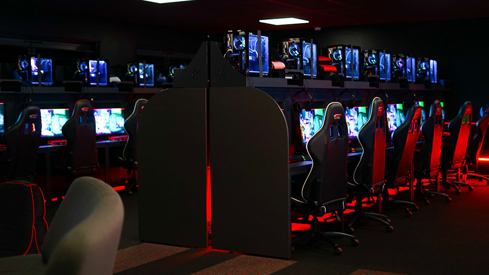 Nucastle finished esports arena showing desks and screen with lighting