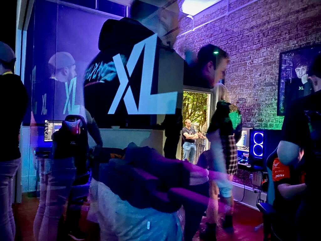 XL LAUNCH 2 LX launch party - reflections in windows - people, screens, XL logo