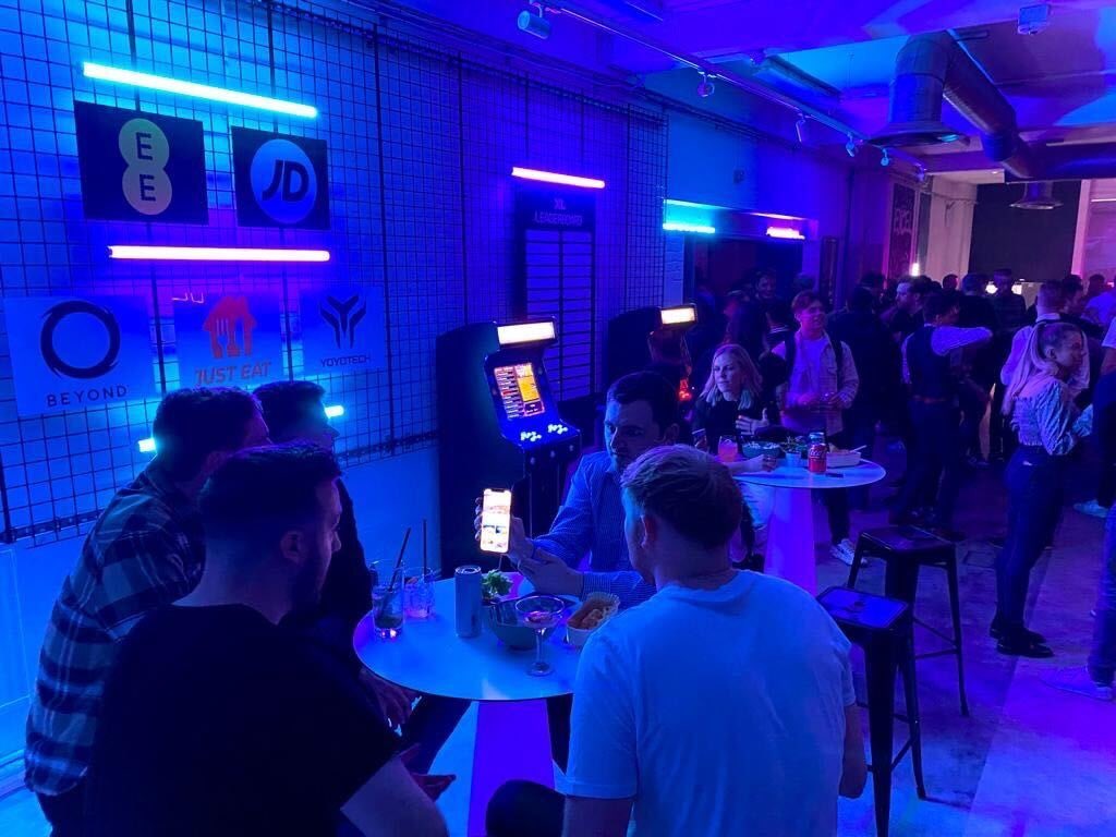 XL LAUNCH 3 XL headquarters launch party - tables, people low lighting